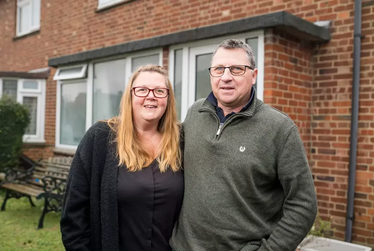 A couple outside their home bought with Your Home