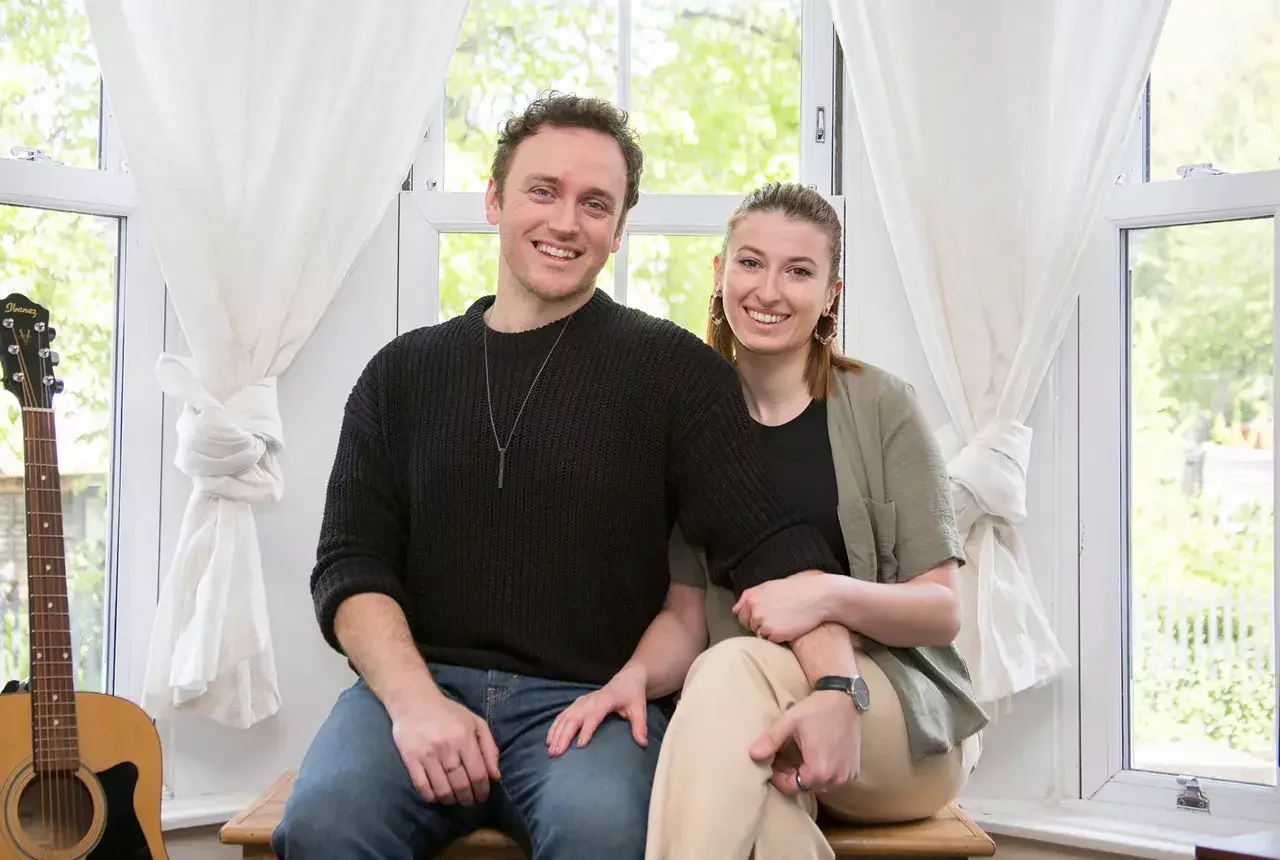 A couple sat in their home they bought with Your Home