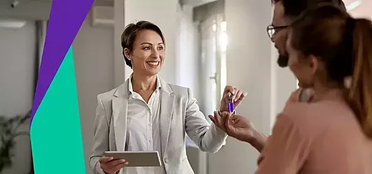 Estate agent handing over the keys to new Your Home shared ownership homeowners